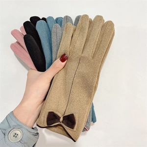 Close-up of warm winter gloves with fleece lining and cute bow detail on the wrist