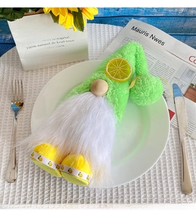 Dining table setting featuring a gnome plush with lemon decor on a white ceramic plate