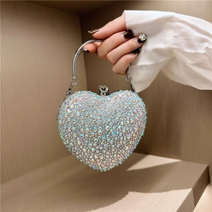 Sparkling heart-shaped clutch bag with iridescent rhinestones and silver metal handle
