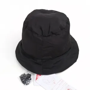Detail of black insulated bucket hat with included windproof chin strap and polyester tag