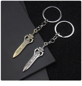 Detailed close-up of bronze and silver vintage sword keychains with ornate metal textures