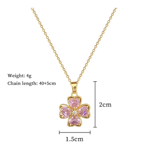 Close-up of pink heart clover pendant necklace with detailed size and weight specs