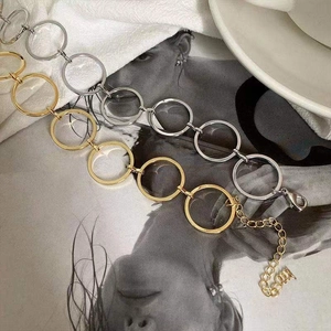 Close-up of gold and silver chunky chain necklaces with lobster clasp on artistic background