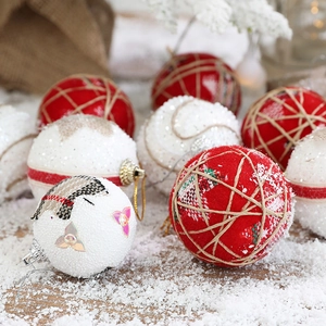 Festive red and white Christmas foam ornaments with embroidery and sequins on snow