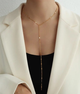 Detail of elegant gold Y-shaped double layer titanium steel necklace on a model