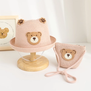 Detail of pink straw sun hat and matching bag set with cute 3D bear ears and embroidery