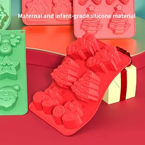 Food-grade silicone Christmas cake molds featuring Santa, trees, and gift shapes in red and green