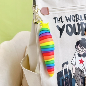 Rainbow jointed slug keychain for bags with a golden lobster clasp and bell accessory