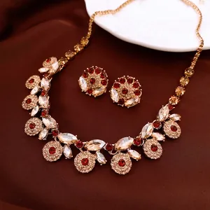 Vintage gold necklace and earring set with red rhinestones in floral court style