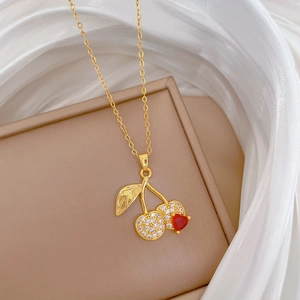 Elegant gold titanium steel necklace with a crystal-studded red cherry pendant design