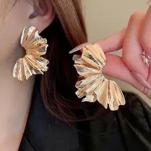 Exaggerated golden fan-shaped pleated earrings with metallic wrinkled texture