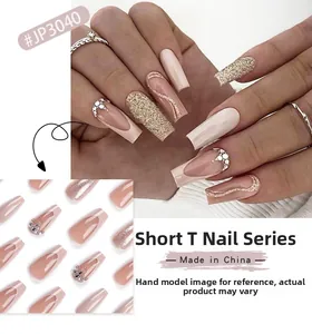 Short coffin press-on nails with nude pink, glitter, French tips and rhinestone accents