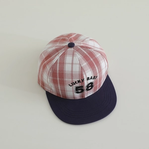 Detail of red plaid pattern with blue brim and LUCKY BABY 58 embroidery on kids hat