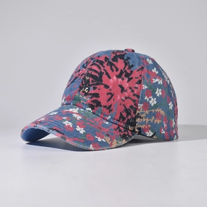 Detailed view of denim baseball cap featuring vibrant floral patterns and cotton texture