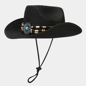 Detail of black straw cowboy hat featuring blue turquoise centerpiece and beaded band