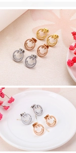 Detailed view of hollow smiley face earrings in gold, silver, and rose gold finishes