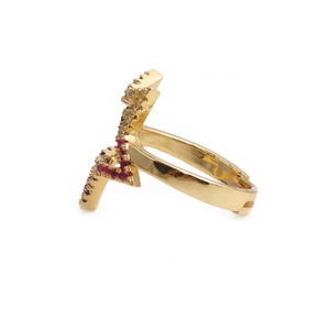 Macro detail of adjustable gold star ring with colorful zircon and red purple enamel