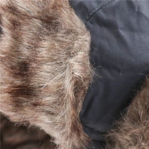 Detail of warm brown faux fur lining and windproof dark gray outer fabric for winter hat