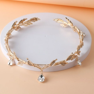 Detail view of golden leaf bridal tiara with sparkling rhinestones and a teardrop pendant