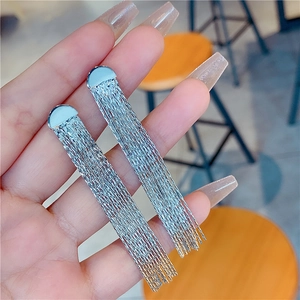 Elegant long silver tassel earrings with heart-shaped base and shimmering metal fringe