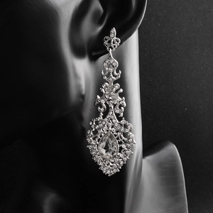 Detail of luxury vintage rhinestone drop earrings with teardrop crystal on black bust