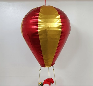 Macro detail of red and gold striped hot air balloon ornament with metallic finish
