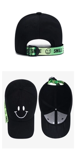Detail of black baseball cap with neon green smile ribbon and embroidered smile logo