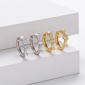 Detail view of gold and silver S925 sterling silver hoop earrings with zircon stones