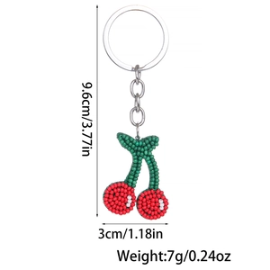 Detailed view of handmade beaded cherry keychain with silver ring and size dimensions