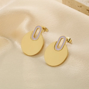 Detail of gold round stud earrings with purple enamel inlay on soft silk background