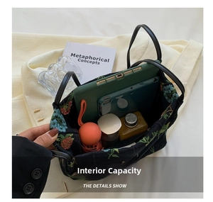 Interior view showing the large capacity of a floral canvas bucket bag with everyday items