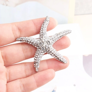 Close-up of a sparkling starfish brooch with silver-tone base and crystal rhinestones