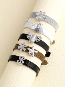 Detail of leather and mesh bracelet bands with crystal bee and starfish charms