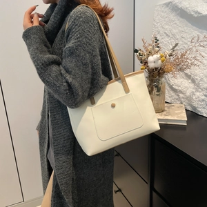 Minimalist off-white large capacity leather tote bag with brown straps for daily commute