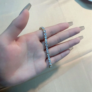 Classic gold tennis bracelet with round-cut cubic zirconia on a female wrist