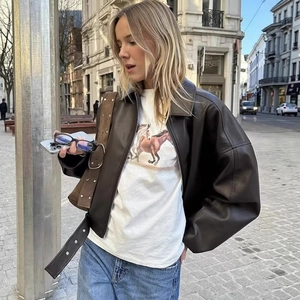 Vintage brown leather jacket with waist belt and long sleeves for a street style look