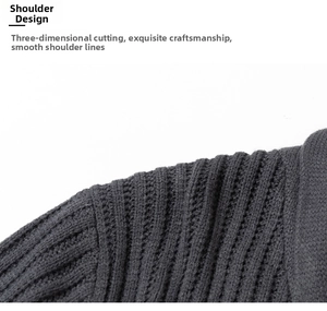 Detailed macro view of the ribbed knit fabric and shoulder seams on a dark grey cardigan