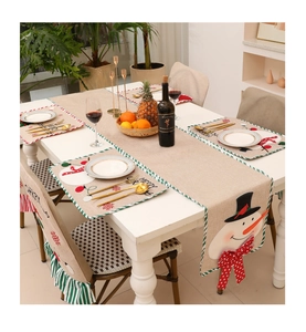 Detailed view of Christmas table runner and placemats with festive snowman embroidery