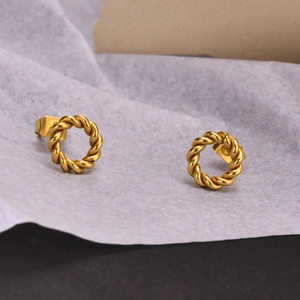 Polished gold twisted hoop earrings in titanium steel with a minimalist woven design