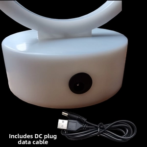 Detail of the white circular base featuring a DC charging port with USB power cable