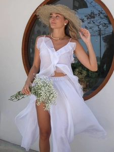 Macro detail of white ruffled V-neck camisole top with sheer lightweight chiffon fabric