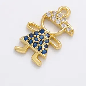 Close-up of gold brass girl pendant with blue and white zircons for jewelry making