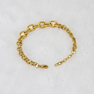 Golden stainless steel double layered chain bracelet for men and women on white fur