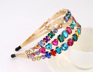 Detail of golden Baroque headband featuring colorful crystals and artificial gemstones