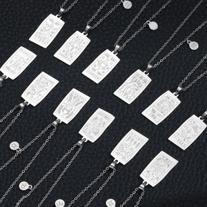 Silver stainless steel zodiac tarot pendants array on premium black leather background