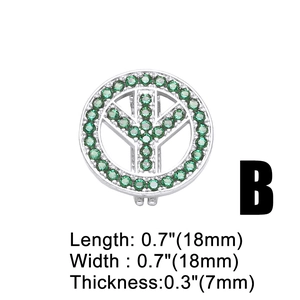 Detailed view of a silver peace sign pendant with pave-set green cubic zirconia crystals