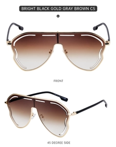 Close-up of brown gradient oversized sunglasses with hollow gold frame and CE marking