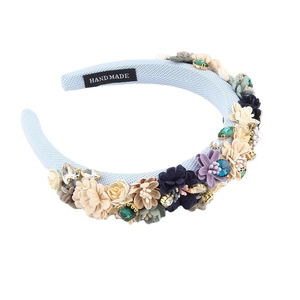 Baroque blue sponge headband with 3D fabric flowers and crystals on a white background