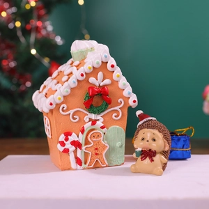 Festive resin gingerbread house and hedgehog figurine set for Christmas decor