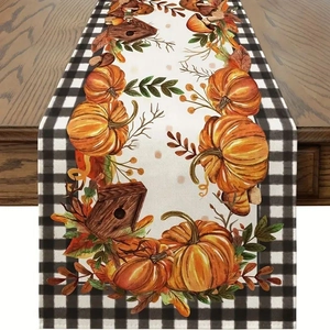 Macro shot of pumpkin birdhouse pattern on plaid table runner over rustic wood surface
